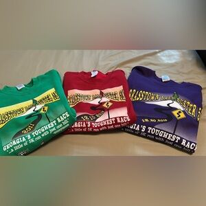Stack of Gildan Sweatshirts - Green, Red, Purple.
